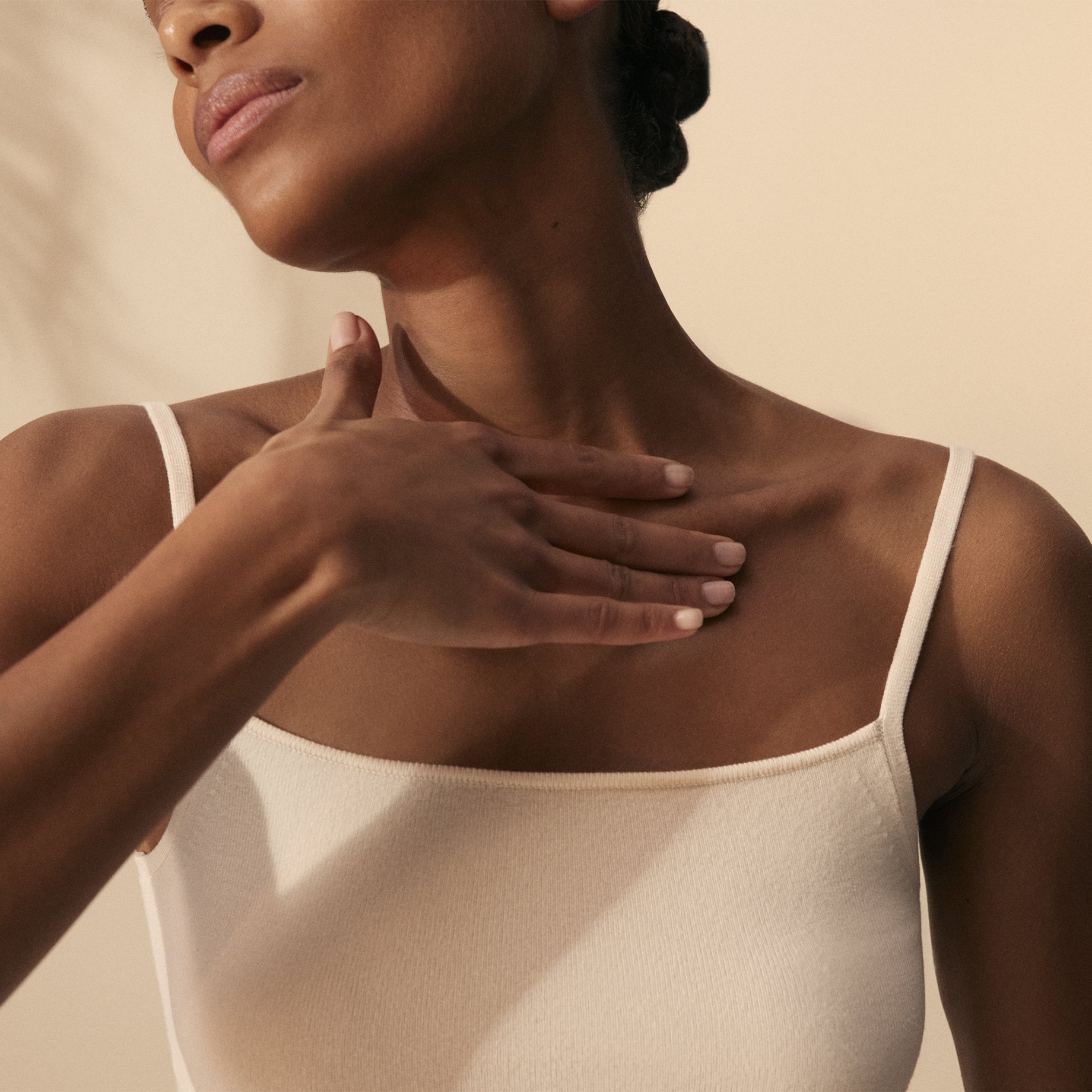 Image of model rubbing collarbones after applying Kumkumadi Serum