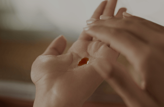 Image of palm with pool of Ayurvedic oil in the middle